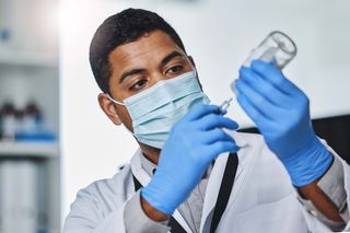 doctor filling syringe with vaccine doctor filling syringe with vaccine