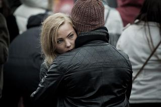 Couple embracing in a public place Couple embracing in a public place