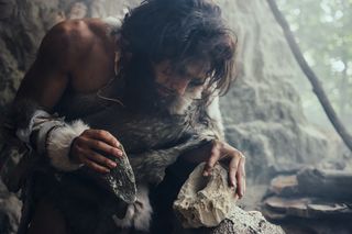 Early human using stone tools