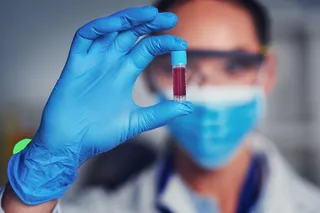 doctor holding a vile of blood