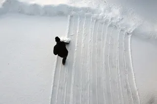Personal shoveling snow from aerial view point.