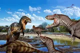 Illustration of adult Nanotyrannus (left) and two juvenile T. rex in a face-off during the Late Cretaceous