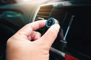 Turning down the music knob in a car