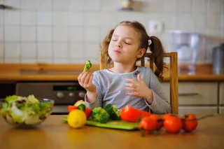 little girl enjoying her veggies little girl enjoying her veggies