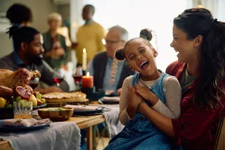Happy family sitting around a table at Christmas