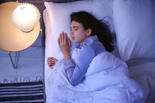 woman sleeping in bed, dreaming 