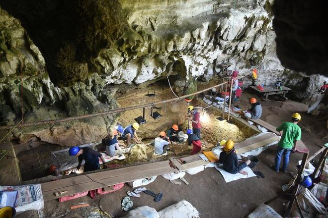 researchers excavating a cave site in Indonesia