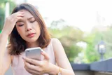 woman stressed out looking at her phone