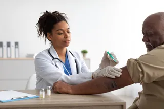a patient receiving a vaccine from a doctor