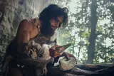 early human using stone tools at their camp 