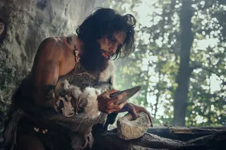 early human using stone tools at their camp 