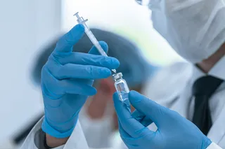 Scientist holds a vaccine that may be in development