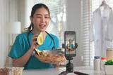 female medical professional filming a nutritional video in her kitchen