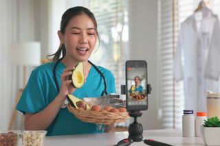 female medical professional filming a nutritional video in her kitchen