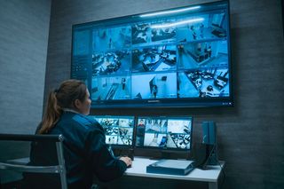 security guard monitors screens 