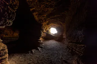 A small cave opening with light coming in 