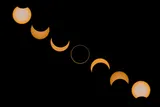 time-lapse photo of a solar eclipse showing the different phases of the moon covering the sun