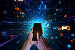A person holding a smartphone surrounding by different social media icons.