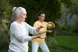 Group of people doing Tai Chi Chuan in a park