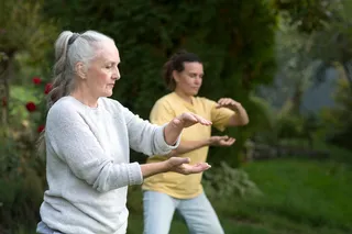 Group of people doing Tai Chi Chuan in a park