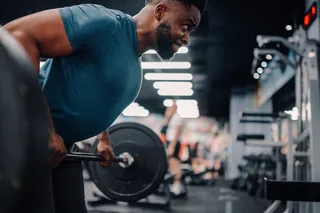 Athlete lifting weights, as an example of willpower