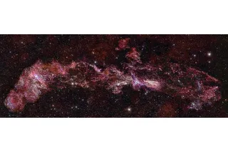 image spanning the milky way in vibrant red stars and gas 