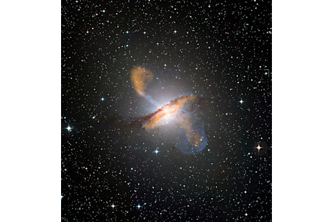 This image of Centaurus A, an active galactic nucleus ejecting material from its center, combines X-ray, microwave, and visible light images. (Credit: ESO/WFI (visible); MPIfR/ESO/APEX/A.Weiss et al. (microwave); NASA/CXC/CfA/R.Kraft et al. (X-ray))