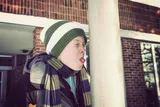 boy sticking his tougne out to lick a cold pole 