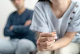 Close up of person holding wedding ring during marriage problems