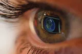 Close up of an eye looking at a computer screen 