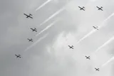 multiple cloud seeding planes flying through the cloudy sky