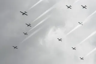 multiple cloud seeding planes flying through the cloudy sky