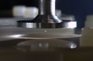 acoustic levitation device with a single sphere suspended mid air. 