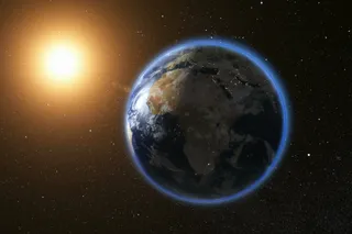 Planet Earth in space with the sun shining on it 