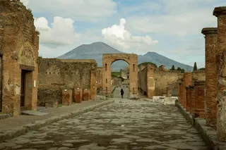 a street and ruins of the city of Pompeii