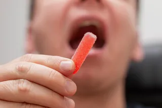 Person eating a sour candy