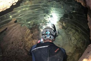 John Moretti snorkeling in Bender's Cave in central Texas, finding fossils