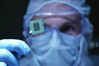 Person holding an example of a microchip close to the camera