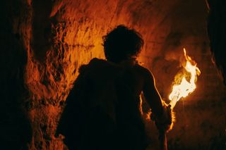 Early hominin walking with fire or charcoal