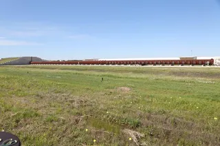 Texas A&M Detonation Research Test Facility showing a nearly 500-foot-long detonation tube with thick steel walls and an earth-covered muffler