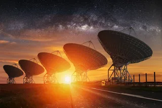 Radio telescopes pointed at the starry sky while the sun sets 