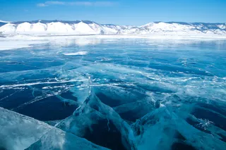 Ice cracking in the Arctic, near mountains
