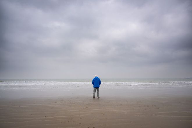 Sir David Attenborough standing near the sea