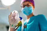 nurse holding an anesthesia mask 