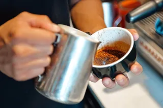 a barista pouring coffee