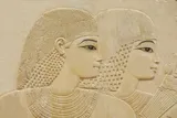 Ancient Egyptian relief of two women with dark eyeliner on
