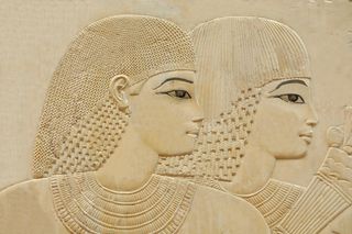 Ancient Egyptian relief of two women with dark eyeliner on