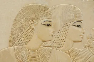 Ancient Egyptian relief of two women with dark eyeliner on
