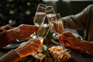 Friends cheering four glasses of champagne glasses