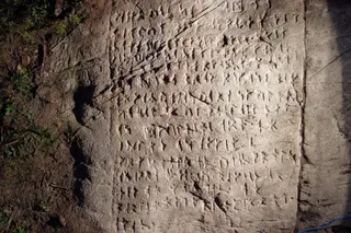 old runes carved into a large white stone 